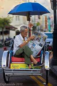 Rickshaw driver on break. One of the best ways to get around downtown if you don't have your own bicycle